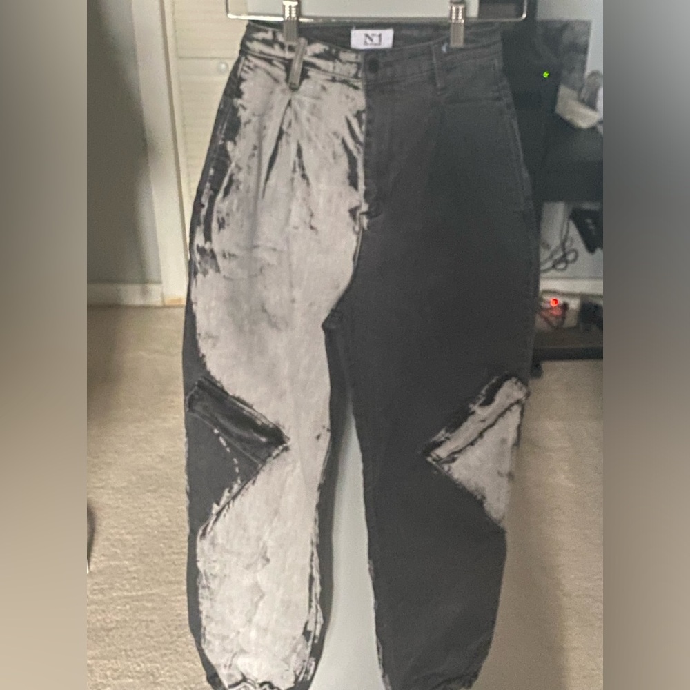 Black distressed denim jeans. Oversized fit, cinch waist, elastic bottom.